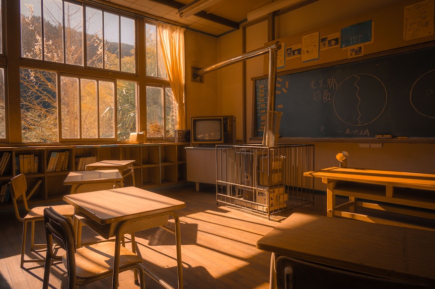 An empty mid-century classroom in afternoon light, with wooden desks, a blackboard, and shelves of books