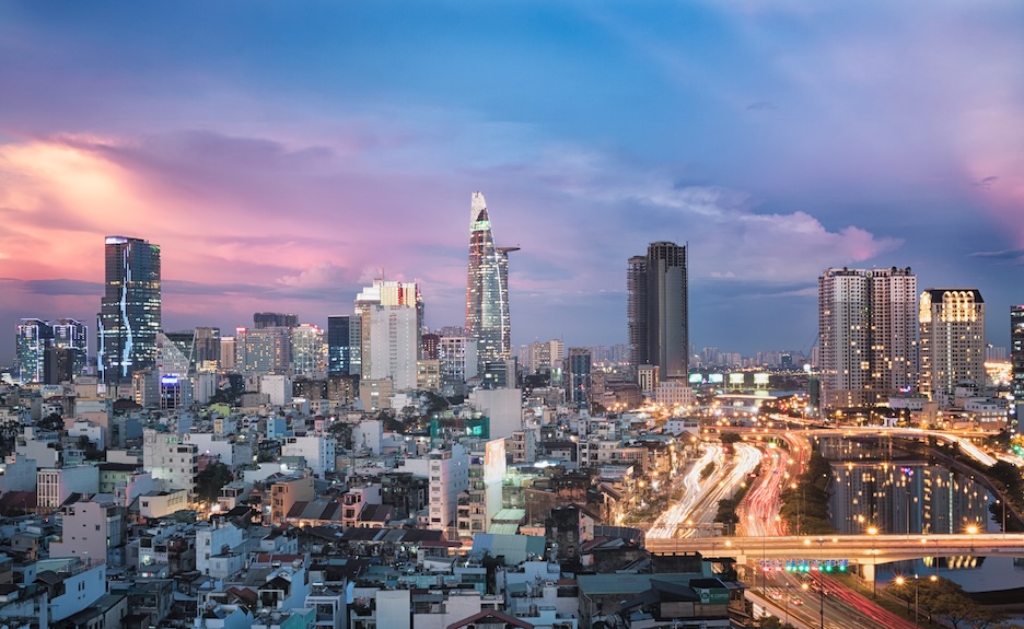 Hồ Chí Minh City skyline at dusk, with the Bitexco Financial Tower above the older districts